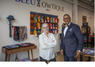 Sue Mosey stands with small business owner in Detroit